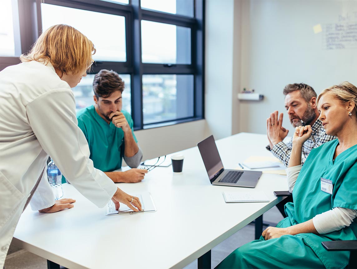 Group of doctors sitting down in discussion